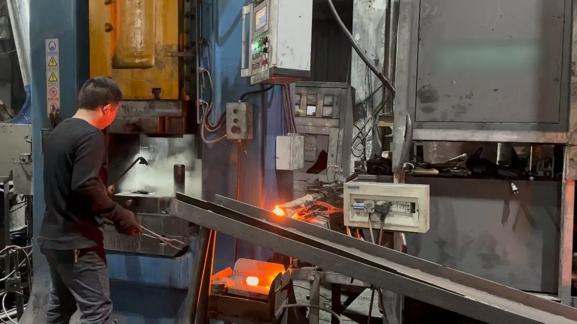 Induction-heated bar fed to the press at a partner plant